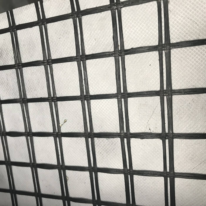 Geomalla compuesta de poliéster con geotextil